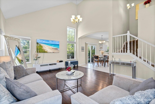 373 Wagonwood Rd, Round Lake, IL 60073 - living area with stairs, wood finished floors, high vaulted ceiling, an inviting chandelier, and arched walkways
