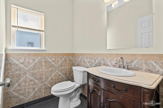 373 Wagonwood Rd, Round Lake, IL 60073 - bathroom featuring vanity, toilet, tile walls, and a wainscoted wall