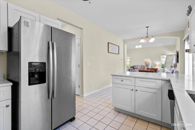 373 Wagonwood Rd, Round Lake, IL 60073 - kitchen featuring a notable chandelier, pendant lighting, light tile patterned flooring, stainless steel fridge with ice dispenser, and white cabinets