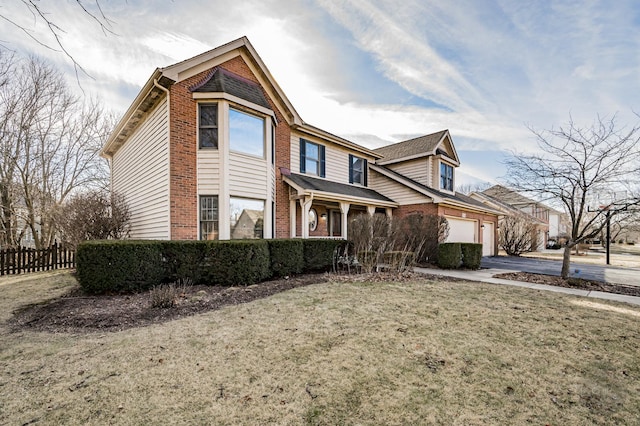 view of front of property featuring a garage and a front yard