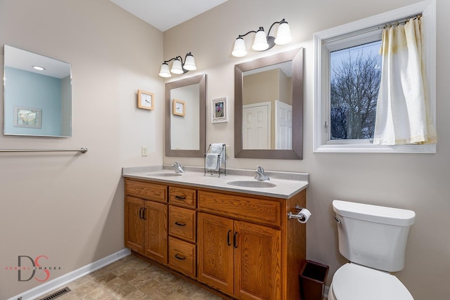 bathroom with vanity and toilet