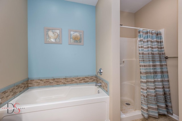 bathroom featuring shower with separate bathtub