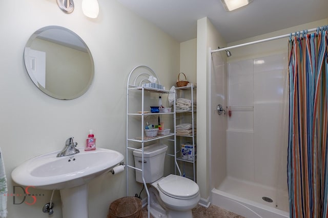 bathroom featuring walk in shower and toilet