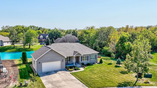 view of front of property with a garage and a front lawn