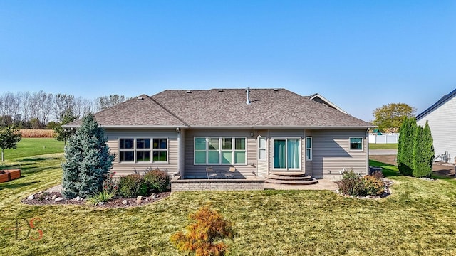 back of house with a lawn and a patio