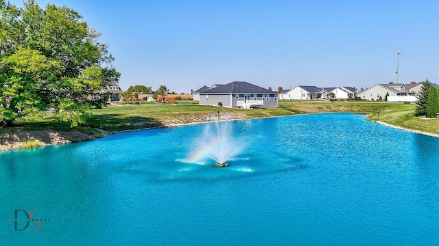 view of pool with a water view and a yard