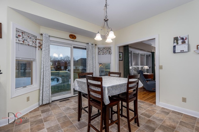 dining space featuring a notable chandelier