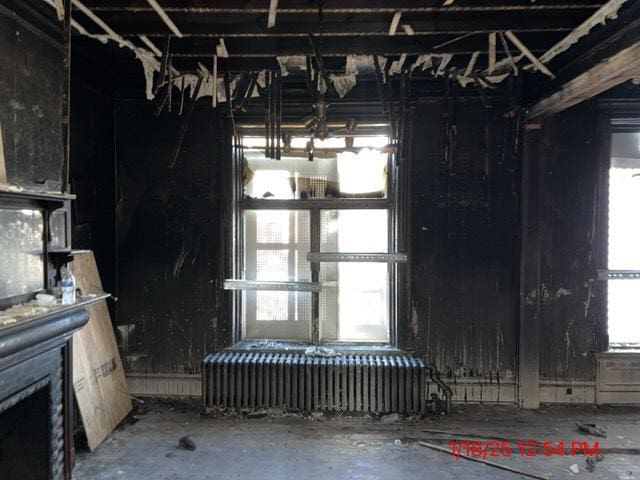 miscellaneous room with radiator heating unit and plenty of natural light