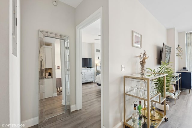 hallway with hardwood / wood-style floors