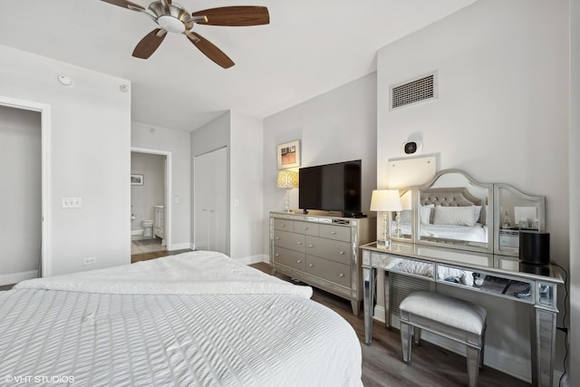 bedroom with connected bathroom, ceiling fan, and a closet