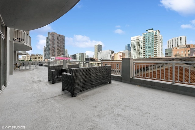 view of patio / terrace with a balcony and an outdoor hangout area