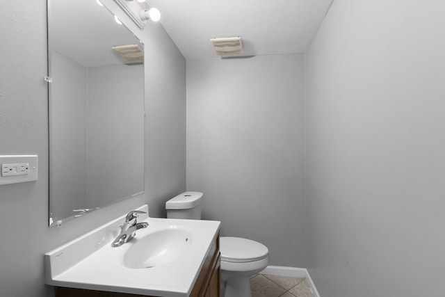 bathroom featuring tile patterned flooring, vanity, and toilet