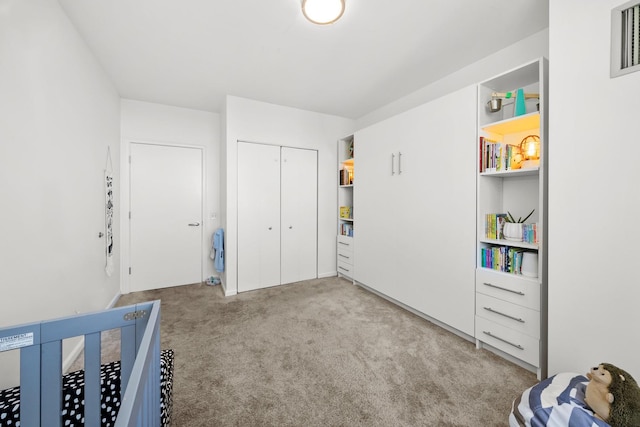 carpeted bedroom with a closet