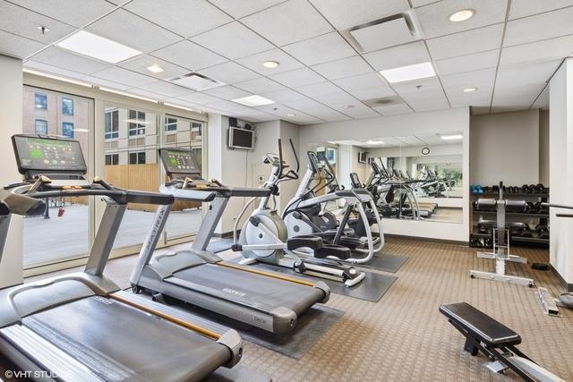 gym featuring a drop ceiling and carpet flooring