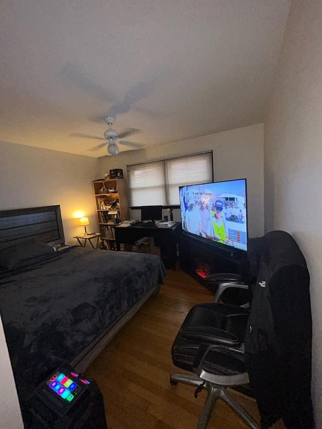 bedroom featuring hardwood / wood-style flooring and ceiling fan