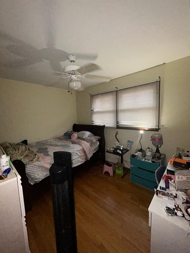 bedroom featuring ceiling fan and dark hardwood / wood-style floors