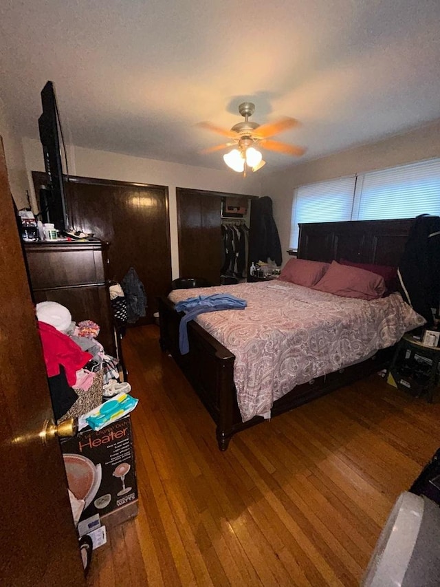 bedroom with wood-type flooring and ceiling fan