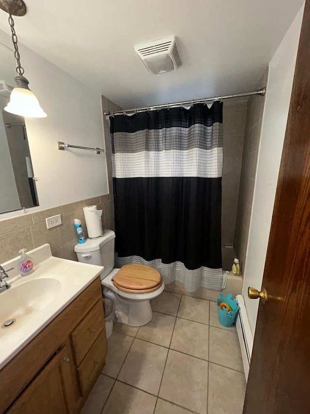 bathroom featuring tile walls, tile patterned flooring, vanity, walk in shower, and toilet