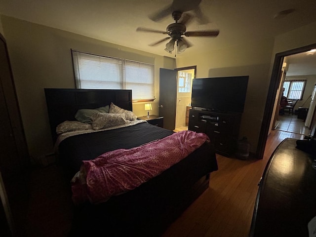 bedroom featuring ceiling fan, ensuite bathroom, and hardwood / wood-style floors