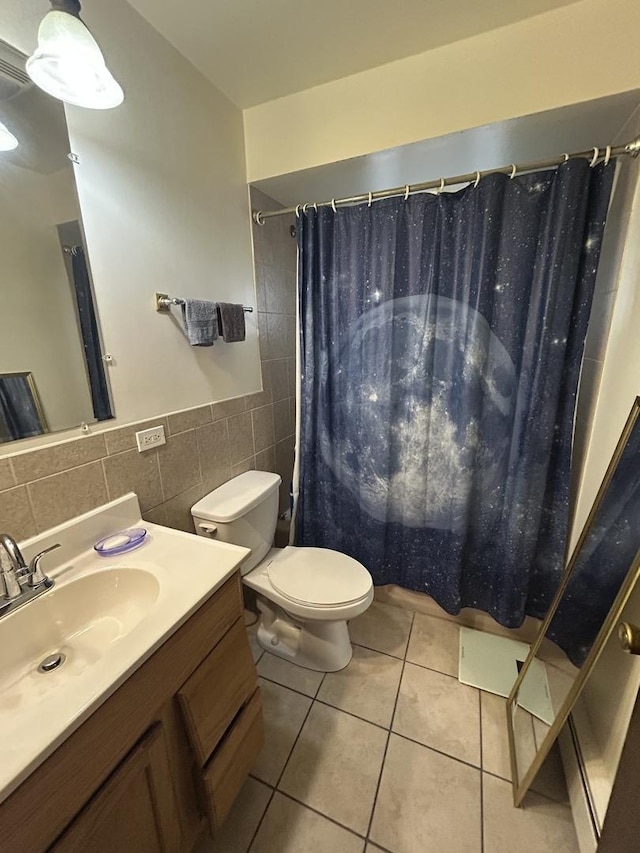 bathroom featuring tile walls, vanity, walk in shower, toilet, and tile patterned floors