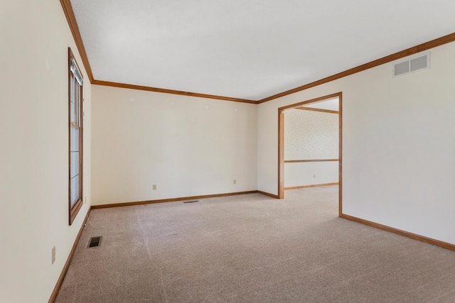 empty room featuring baseboards, visible vents, crown molding, and light colored carpet