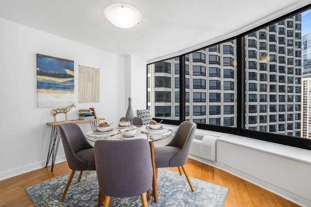 dining space with hardwood / wood-style floors