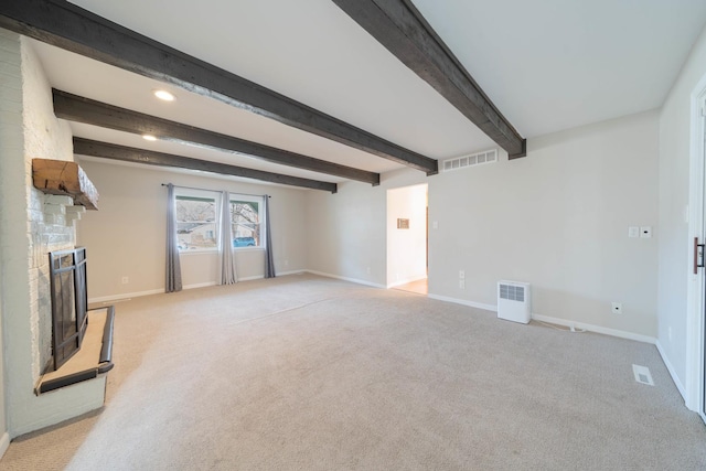 unfurnished living room with beam ceiling, light colored carpet, and a fireplace