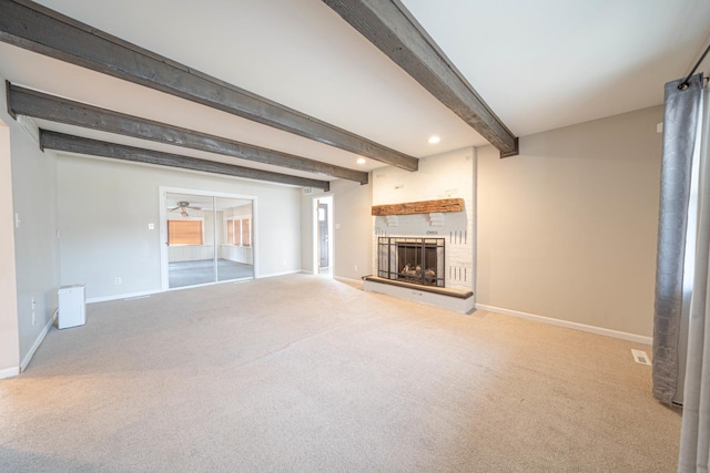 unfurnished living room featuring carpet floors, a fireplace, and beamed ceiling