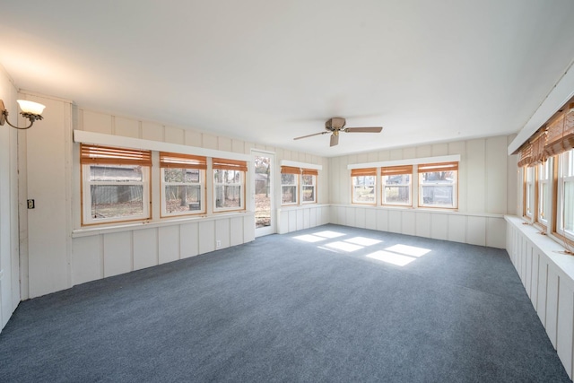 unfurnished sunroom with ceiling fan and a healthy amount of sunlight