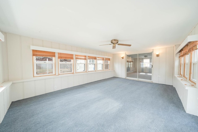 unfurnished sunroom featuring ceiling fan