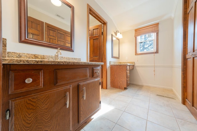 bathroom featuring tile patterned flooring, vanity, and ornamental molding