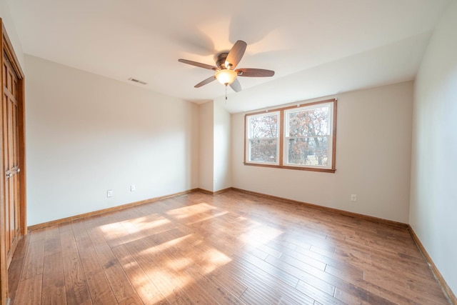 spare room with ceiling fan and light hardwood / wood-style flooring