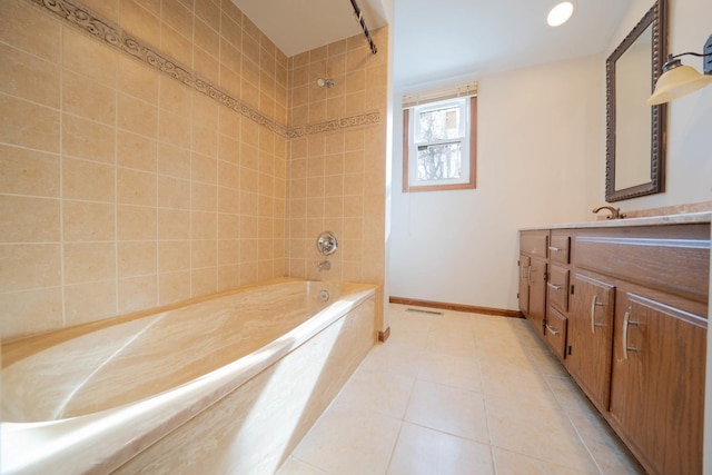 bathroom featuring tile patterned flooring, vanity, and tiled shower / bath combo