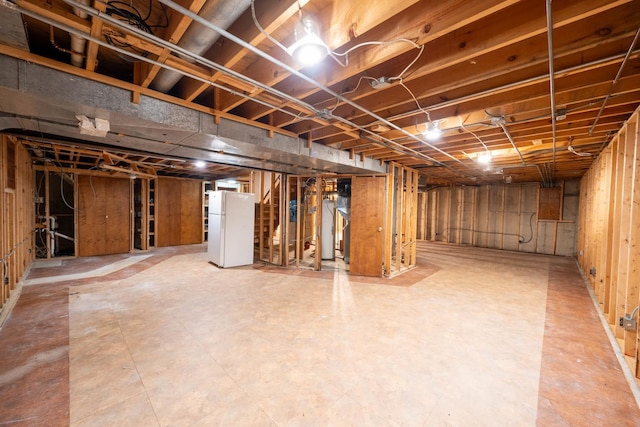 basement with white refrigerator