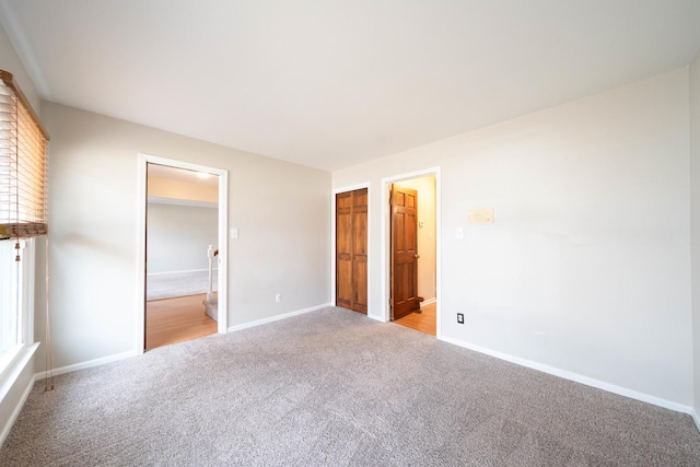 unfurnished bedroom featuring light colored carpet