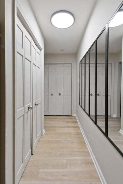 hallway with light hardwood / wood-style flooring