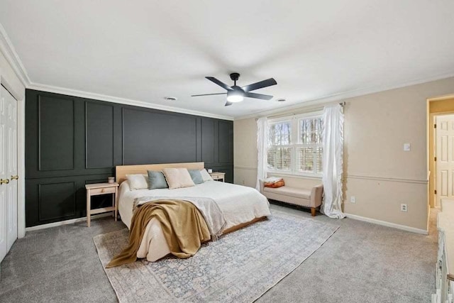 carpeted bedroom with crown molding and ceiling fan