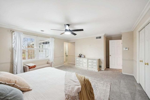 carpeted bedroom featuring crown molding and ceiling fan