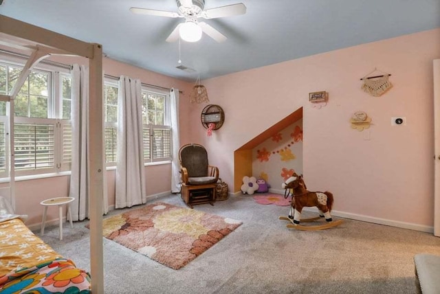 living area with carpet floors and ceiling fan