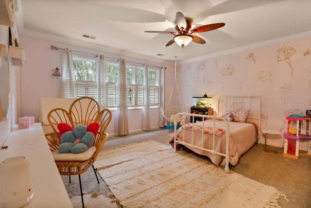 carpeted bedroom featuring crown molding and ceiling fan