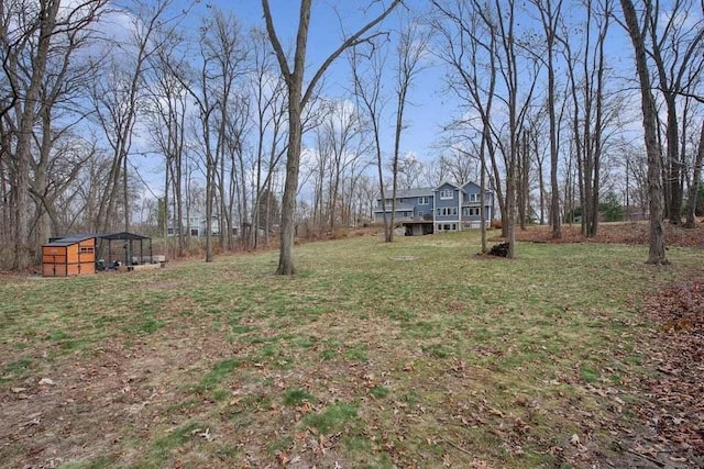 view of yard featuring a wooden deck and an outdoor structure