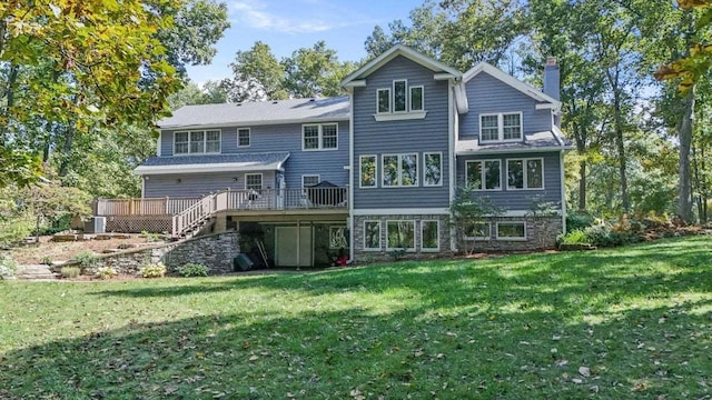 back of property with a lawn and a deck