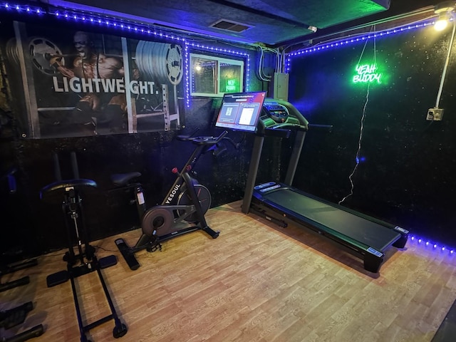 exercise room with hardwood / wood-style floors