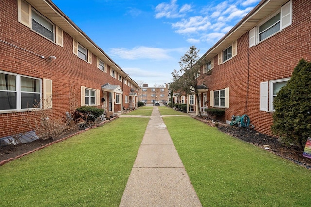 view of property's community featuring a lawn