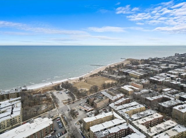 birds eye view of property with a water view and a beach view