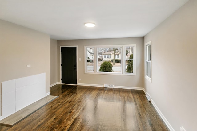 spare room with dark hardwood / wood-style floors