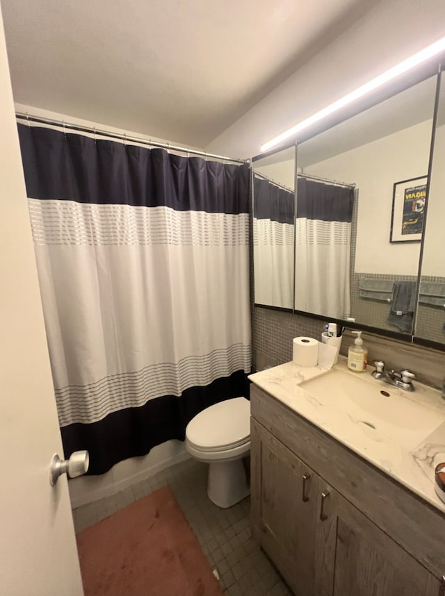 bathroom featuring vanity, tile patterned floors, toilet, and a shower with shower curtain