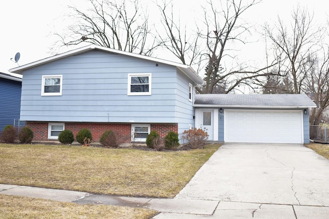 tri-level home featuring a garage and a front yard