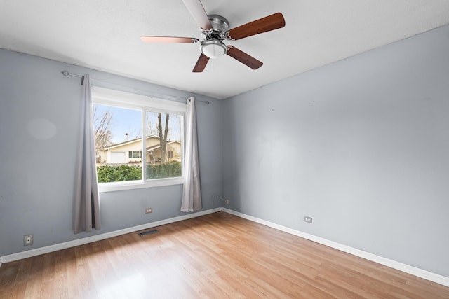 unfurnished room with ceiling fan and light wood-type flooring