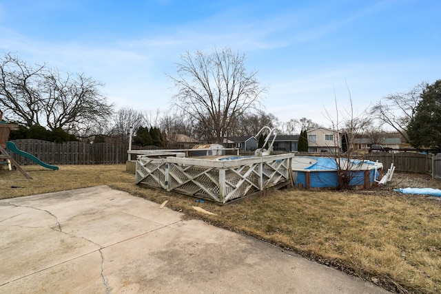 exterior space featuring a fenced in pool and a playground